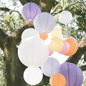 Beautiful multicolor round paper lanterns hanging outdoors for wedding and festival decoration