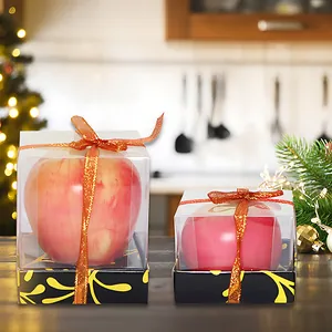 Par de velas decorativas de manzana roja simulada en cajas de regalo con lazos de color naranja