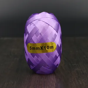 Close-up of 5mm x 10m purple balloon ribbon roll for party decorations.