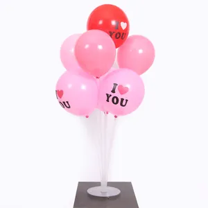 Close-up of pink and red 'I Love You' balloons arranged on a clear table stand