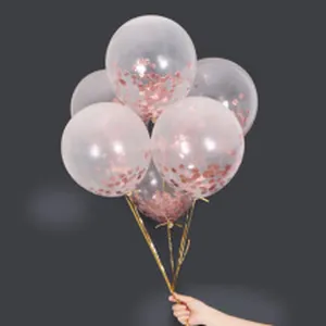 Detailed view of clear transparent balloons filled with decorative rose gold confetti