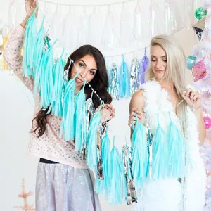 Models holding 35cm mint green and silver paper tassels for birthday party decorations