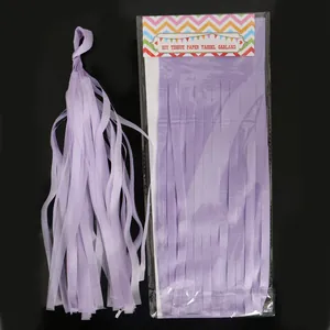 Detail of purple DIY tissue paper tassel garland set showing packaging and assembly