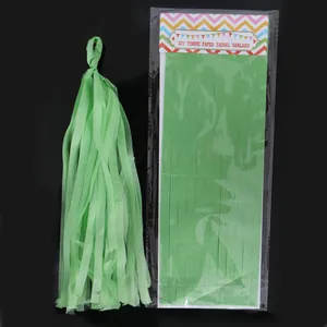 Close-up of green tissue paper tassel and its DIY packaging for party decoration