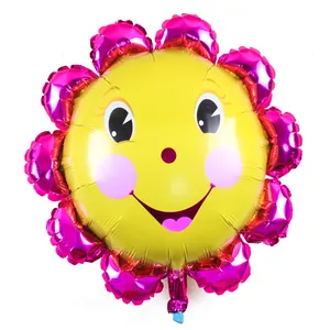 Detailed view of a smiling sunflower foil balloon with vibrant pink petals and yellow center.
