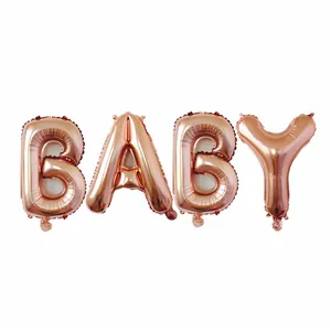 Close-up detail of rose gold 'BABY' aluminum film balloons for birthday party decor
