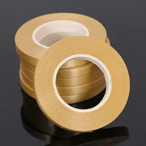 Close-up detail showing the metallic texture of gold curling ribbon rolls for balloon decor