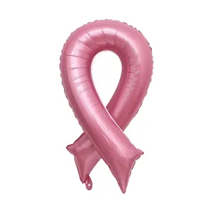 Detailed macro view of pink ribbon shaped foil balloon with metallic luster finish