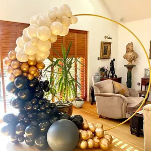 Gold circular metal balloon arch frame shown decorated in a luxury living room