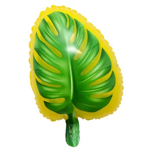 Vibrant green and yellow Monstera leaf foil balloon for tropical Hawaii party decor.