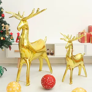 Large and small golden standing reindeer foil balloons for festive Christmas party decoration