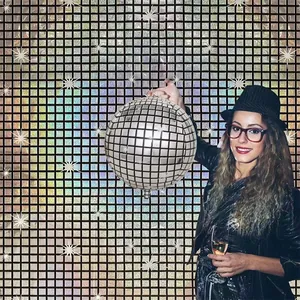 Silver shimmering laser grid backdrop with disco ball balloon for party decorations