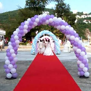 Beautiful outdoor wedding ceremony scene with arches made of purple and white latex balloons