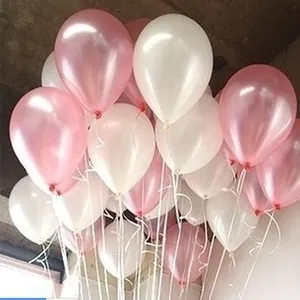 Detailed view of elegant pink and white pearlescent latex balloons with matching white ribbons