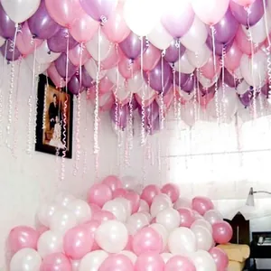 Interior room filled with festive pink white and purple pearl latex balloons for decoration