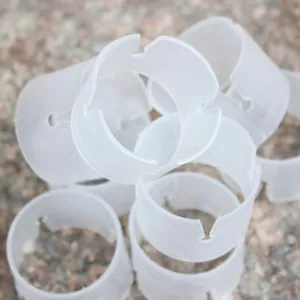 Macro detail showing the structure of white plastic balloon ring clips for arch decoration