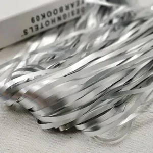 Close-up macro view of shimmering silver metallic foil fringe streamers for party decor