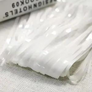 Close-up detail showing the texture of white metallic fringe tinsel curtain backdrops