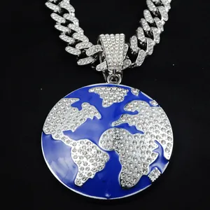 Close-up of a silver Cuban link chain featuring a sparkling blue world map pendant.