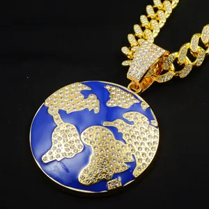Close-up of hip-hop earth pendant necklace with gold Cuban link chain and rhinestones