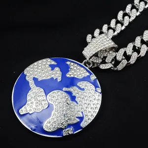Close-up detail of a hip hop iced out globe pendant with blue enamel and cuban link chain