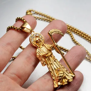 Close-up detail of a gold Santa Muerte reaper pendant with sparkling stones