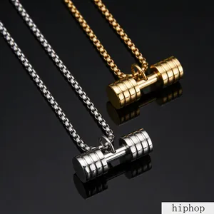 Detail view of gold and silver barbell pendants on high-quality stainless steel chains.