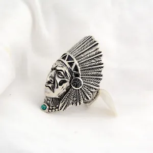 Close-up detail of a vintage Indian Chief warrior ring with turquoise stone inlay for men.