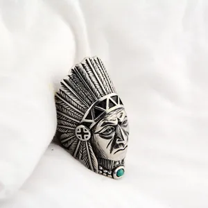 Detailed close-up of vintage steel Indian chief ring with turquoise accent