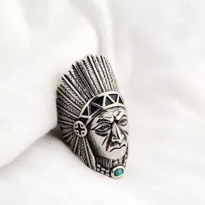 Detailed macro shot of a vintage titanium steel Native American chief ring with turquoise