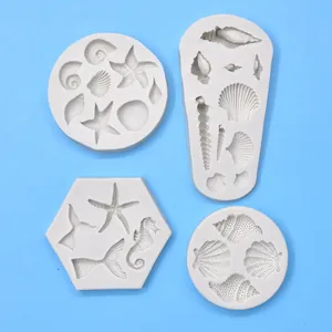 Detail view of various sea shell and starfish white silicone molds for DIY fondant decoration