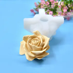 Macro view of 3D rose silicone mold and finished beige aromatherapy candle flower
