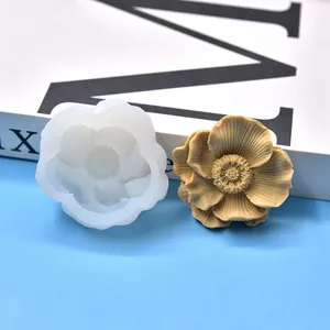 Close-up view of a 3D flower silicone mold and its detailed floral wax ornament result