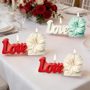 Hibiscus flower and Love letter scented candles in red, cream, and mint green colors.