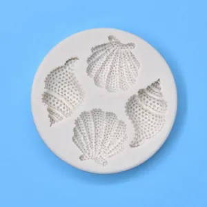 High-definition macro view of a white silicone mold featuring detailed seashell and conch shapes