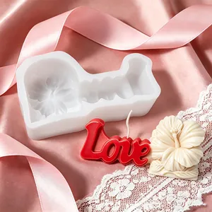 Close-up of hibiscus flower and Love candle next to its white silicone mold