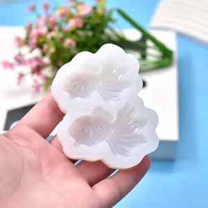 Close-up detail view of white silicone goldfish mold for DIY cake decorating and resin art projects