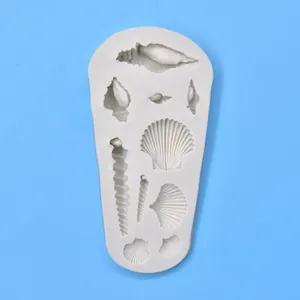White silicone mold with detailed ocean shell and conch shapes for DIY crafts.