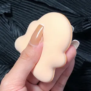 Close-up detail of a soft peach cloud-shaped marshmallow makeup sponge puff texture