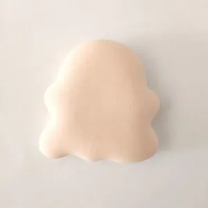 Detailed view of a cute ghost-shaped marshmallow makeup puff with a soft velvet texture