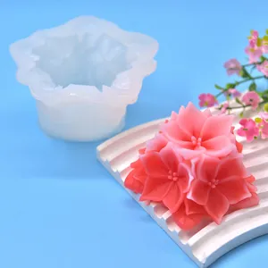 Macro view of a 3D floral silicone mold shown with a finished pink flower craft candle
