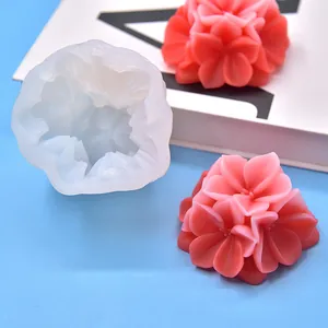 Macro detail of flower silicone mold with finished pink wax flower samples.