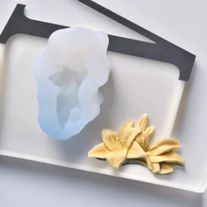 Detail view of 3D lily flower silicone mold with finished yellow wax floral pieces