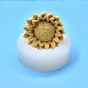 Sunflower silicone mold showing a detailed yellow sunflower candle inside the white mold