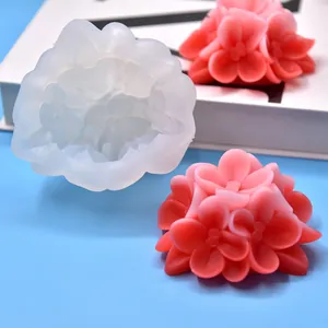 Detailed view of flower-shaped silicone mold with finished pink floral aroma candles