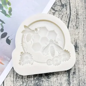Macro detail showing intricate bee and honeycomb patterns on a high-quality white silicone mold.