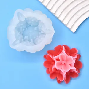 Detailed view of 3D flower silicone mold next to a pink wax flower finished product