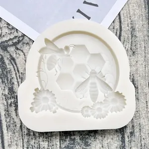 Close-up of silicone mold with detailed honeybee, honeycomb, and daisy pattern