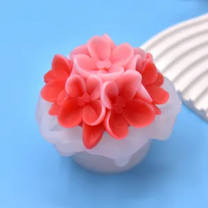 Detailed macro view of a 3D flower silicone mold featuring a finished pink floral candle
