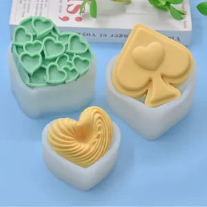 Detail view of heart and spade shaped silicone mousse cake molds with unique textures